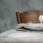 Elegant dining setup featuring a single egg in a minimalist table setting, perfect for spring themes.