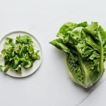 Flat lay of romaine lettuce and mixed greens on a plate, perfect for healthy eating.