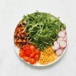 Colorful and healthy salad with mixed vegetables on a white background.
