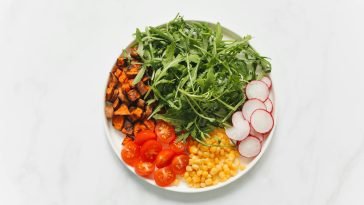 Colorful and healthy salad with mixed vegetables on a white background.