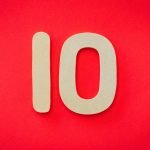 Wooden number 10 on a vibrant red background, ideal for educational and creative projects.