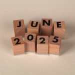 Wooden blocks displaying the text 'June 2025' in a neat arrangement.