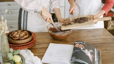 Two people preparing chocolate dessert with ingredients in a cozy kitchen setting.