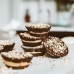 Tasty layered chocolate cupcakes topped with nuts, perfect dessert indulgence.