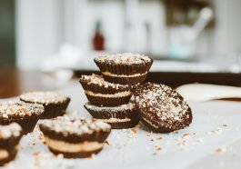Tasty layered chocolate cupcakes topped with nuts, perfect dessert indulgence.