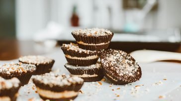 Tasty layered chocolate cupcakes topped with nuts, perfect dessert indulgence.
