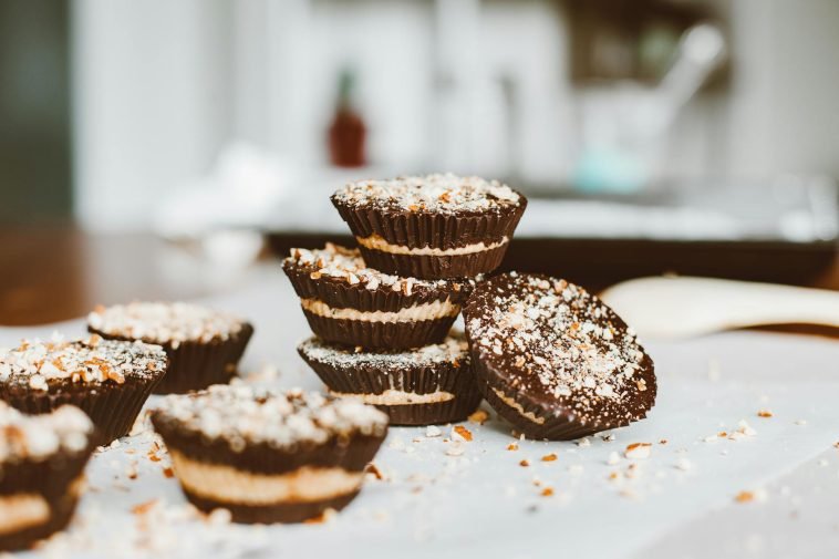 Tasty layered chocolate cupcakes topped with nuts, perfect dessert indulgence.
