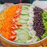 A vibrant vegetable salad platter showcasing fresh ingredients arranged beautifully for a healthy meal.