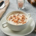 A savory bowl of creamy chicken and mushroom soup garnished to perfection.