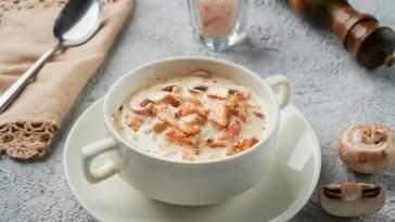 A savory bowl of creamy chicken and mushroom soup garnished to perfection.