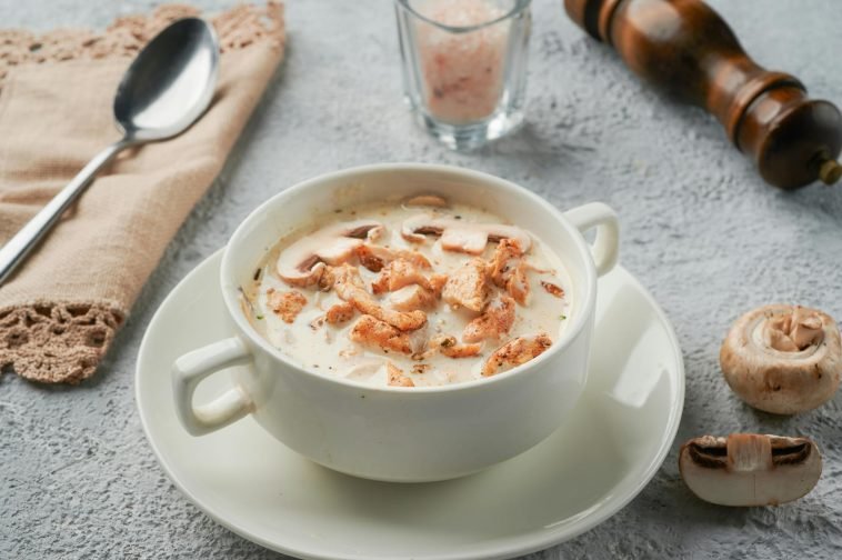 A savory bowl of creamy chicken and mushroom soup garnished to perfection.