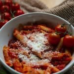 Tasty penne pasta in a rich tomato sauce, topped with parmesan cheese.
