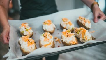 Close-up of stuffed twice-baked potatoes with cheese, ready to serve.