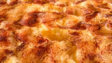 Delicious close-up of grilled mashed potato topping with golden brown crust and spices.