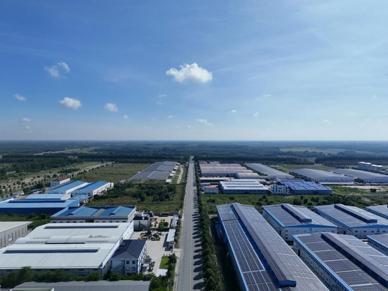 Aerial view showcasing the vast industrial park landscape under a clear blue sky in Bình Dương, Vietnam.