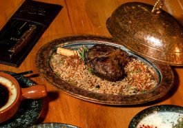 Delicious roasted lamb with fragrant rice served in a copper platter.