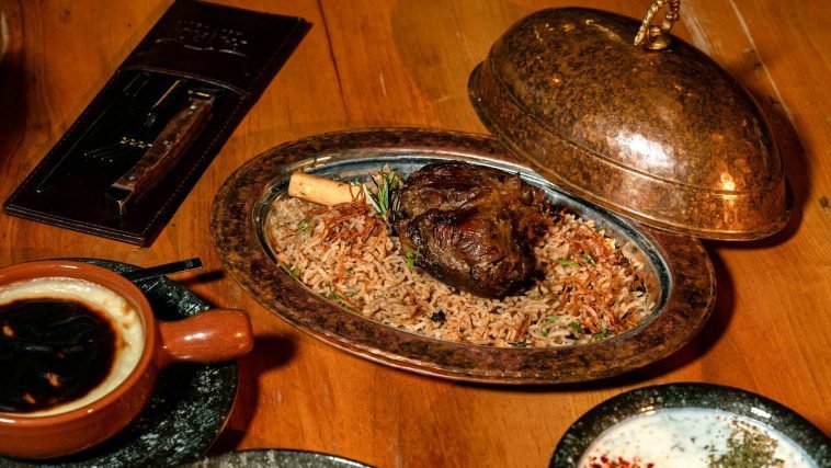 Delicious roasted lamb with fragrant rice served in a copper platter.